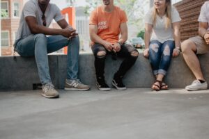 Photo of people sitting and talking by Kate Kalvach on Unsplash